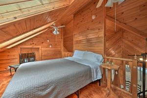 a bedroom with a bed in a wooden room at Waterfront Arkdale Retreat 2 Acres with Deck and View in Arkdale