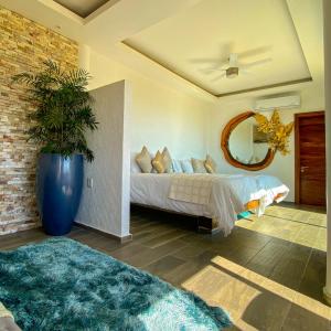 a bedroom with a bed and a large mirror at Muúnek Hotel Boutique Art & Spa in Barra Vieja