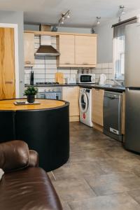 a kitchen with a counter and a stove and a dishwasher at Belfast City self catering 3 bedroom town house in Belfast