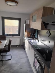 a kitchen with a sink and a counter top at Ferienhaus International in Bad Harzburg