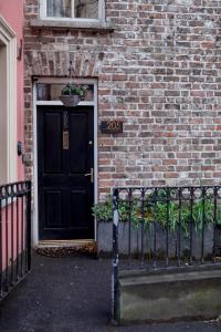a black door with a potted plant on it at Belfast City self catering 3 bedroom town house in Belfast
