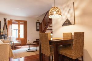 a living room with a dining room table with chairs at El Piolet de Camprodon in Camprodon