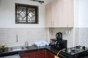 a kitchen with a sink and a microwave at NIKO HOMES in Mombasa