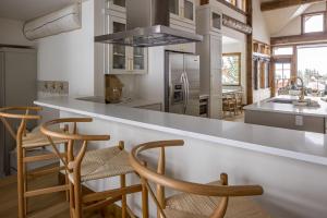 a kitchen with a counter and some wooden stools at Western Tanager Cabin in Big Sky