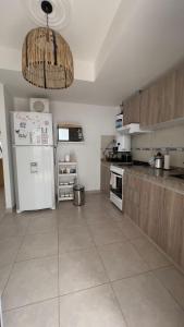 a large kitchen with a white refrigerator at Casa Yaqui in Guaymallen