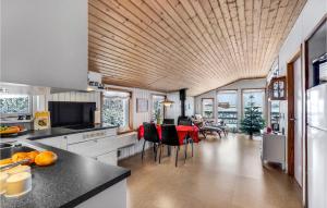 a kitchen with a table and chairs in it at 2 Bedroom Awesome Home In Thyholm in Thyholm