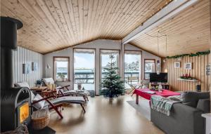 a living room with a christmas tree in the middle at 2 Bedroom Awesome Home In Thyholm in Thyholm