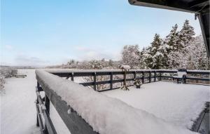 a deck covered in snow on a fence at 2 Bedroom Awesome Home In Thyholm in Thyholm +16 photos
