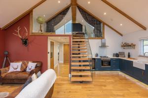 a spiral staircase in a kitchen with blue cabinets at Stags Mount in Pickering