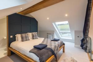 a bedroom with a large bed with a black headboard at Stags Mount in Pickering