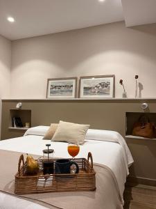 a bedroom with a bed with a basket with a drink on it at La Quintana de Figares in Luarca