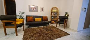 a living room with two chairs and a couch at Fori's Nest / SKG in Thessaloniki