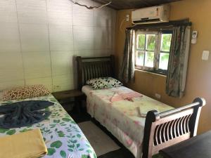 a room with two beds and a window at Pousada São Pedro in Olinda