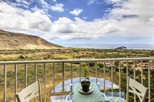 a balcony with a table and chairs and the ocean at Makaha Condo Near Pokai Bay Beach with Ocean View! in Waianae