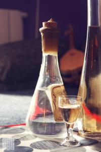 a glass of wine and a bottle on a table at HostelChe Hostel in Belgrade