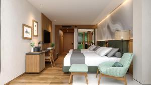 プエルト・バケリソ・モレノにあるHotel Indigo - Galapagos, an IHG Hotelのベッド、デスク、椅子が備わるホテルルームです。