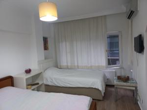 a hotel room with two beds and a window at Silent Corner 1 in Istanbul