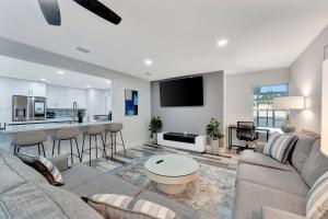 a living room with a couch and a kitchen at Paradise By The River-Hottub/Pool-Near Beaches in Bradenton