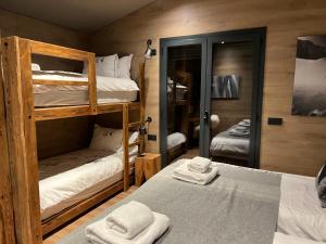 a room with two bunk beds in a cabin at Luxury Summit Penthouse - Soldeu - By Ski Chalet Andorra in Soldeu