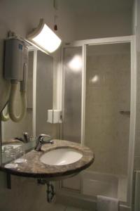 a bathroom with a sink and a shower at Hotel Aquapark Žusterna in Koper