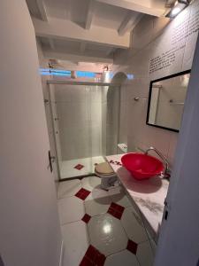 a bathroom with a red sink and a shower at Grande Família Hostel Av paulista in Sao Paulo