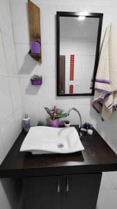 y baño con lavabo blanco y espejo. en ~•handsome apartment for tourists in Medellin, en Medellín
