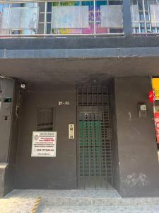 un edificio con una puerta con un cartel. en ~•handsome apartment for tourists in Medellin, en Medellín