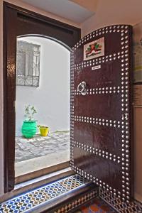an entrance to a room with a wooden door at Riad Darna in Tétouan