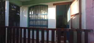 a porch of a house with a door and a fence at El Remanso in Durazno