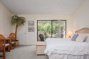 a bedroom with a bed and a table and a window at Summer Place 671 in Ponte Vedra