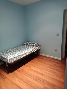 a bed sitting in the corner of a room at Habitación privada en casa particular in Albacete