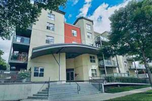 a building with stairs in front of a building at 2 BDRM A/C Condo w/Ensuite Laundry + Free Parking in Edmonton