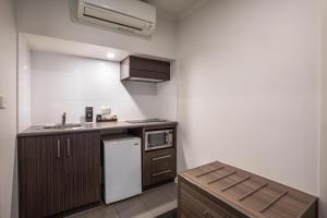 a small kitchen with a sink and a refrigerator at Doncaster Apartments by Nightcap Plus in Doncaster