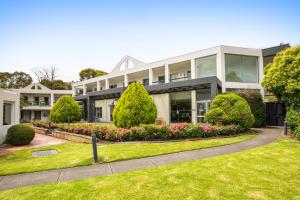 a large house with a garden in front of it at Doncaster Apartments by Nightcap Plus in Doncaster