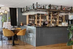 a bar in a restaurant with a table and chairs at Best Western Hotel Halland in Kungsbacka