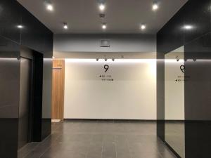 a room with a white wall with signs on it at Apartament 9, z oddzielną sypialnią! in Warsaw