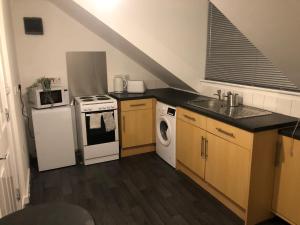 a kitchen with a sink and a stove top oven at 1 bedroom flat Oakfield Road in Bristol