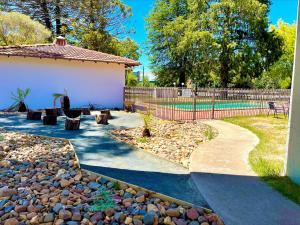 a backyard with a fence and a rock garden at All Seasons Motel Armidale in Armidale