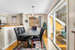 a dining room with a black table and black chairs at Mountainside Resort K204 in Stowe