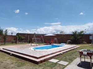 a swimming pool with a slide in a yard at Cabañas Mundo al revés in La Silleta