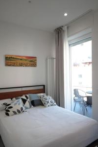 a bedroom with a bed and a large window at [Chiaia] Arcoleo House - Anita in Naples
