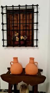 two orange vases sitting on a wooden table at El Alambique in Cazorla