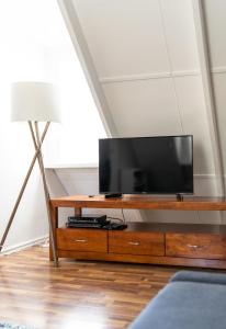 a living room with a tv on a wooden entertainment center at Casa Rua Margaret River in Witchcliffe