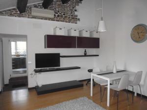 a living room with a table and a computer on a wall at Ca del Lago Misano in Misano Adriatico