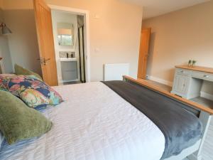 um quarto com uma grande cama branca num quarto em Fron Haul - Robin Goch em Ruthin