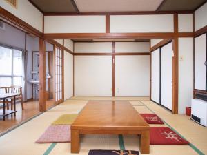 uma sala de estar com uma mesa de madeira num quarto em Harukaze no Yado em Iwaki