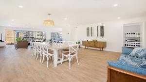a dining room and living room with a table and chairs at 35 Moreton Parade Kings Beach QLD in Caloundra