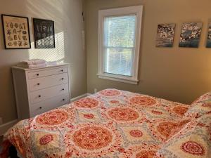 a bedroom with a bed and a dresser and a window at Hunter #1, Private One Bed near Xavier & Downtown in Bellevue