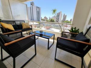 巴拉那的住宿－Paraná Confort，阳台配有椅子、沙发和桌子