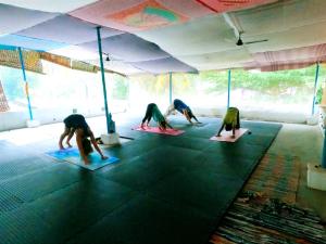 a group of people doing yoga in a room at Casa Eva Luna Ayuryoga Retreat in Varkala